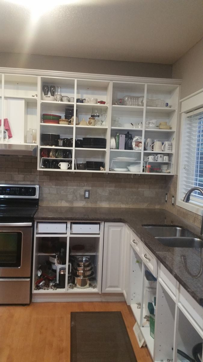 Trendy painted white kitchen cabinets before door re-install