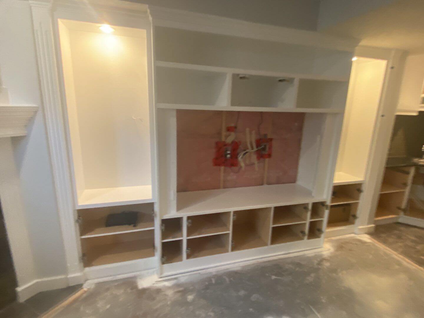 Modern white painted basement TV built-in