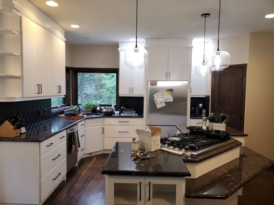 Modern white painted Bragg Creek kitchen with black handles