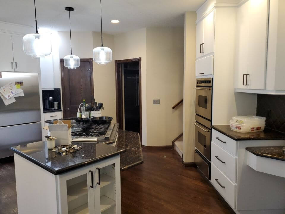 Modern white painted cabinets with black accent hardware Bragg Creek