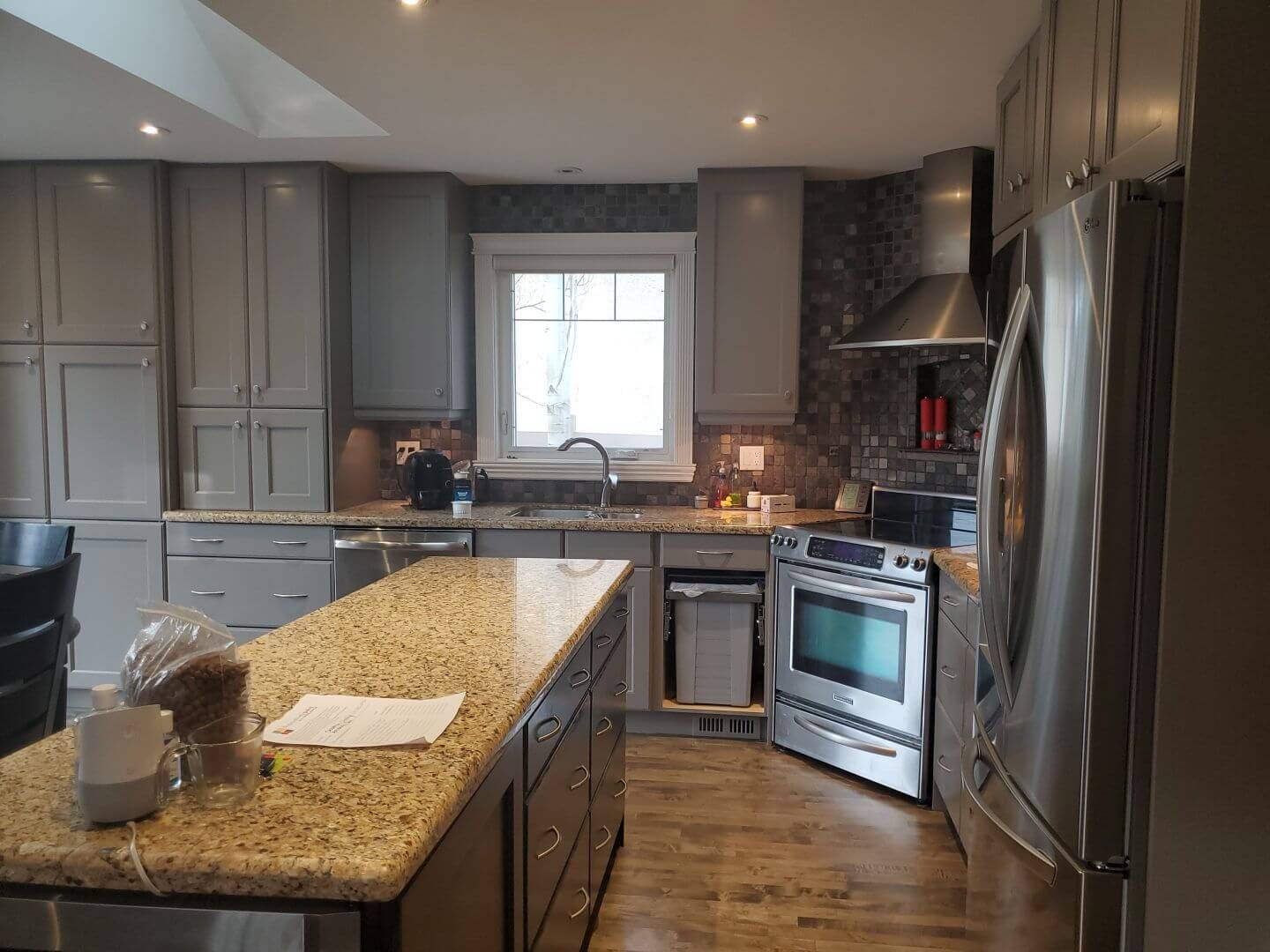 Large open painted grey kitchen with darker accent island