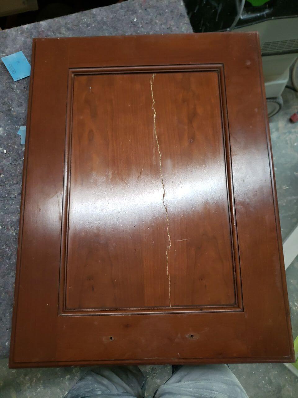 Cabinetry door with a crack through entire middle panel