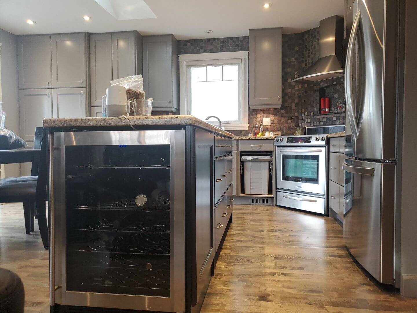 Painted grey kitchen with darker grey island in NE Calgary