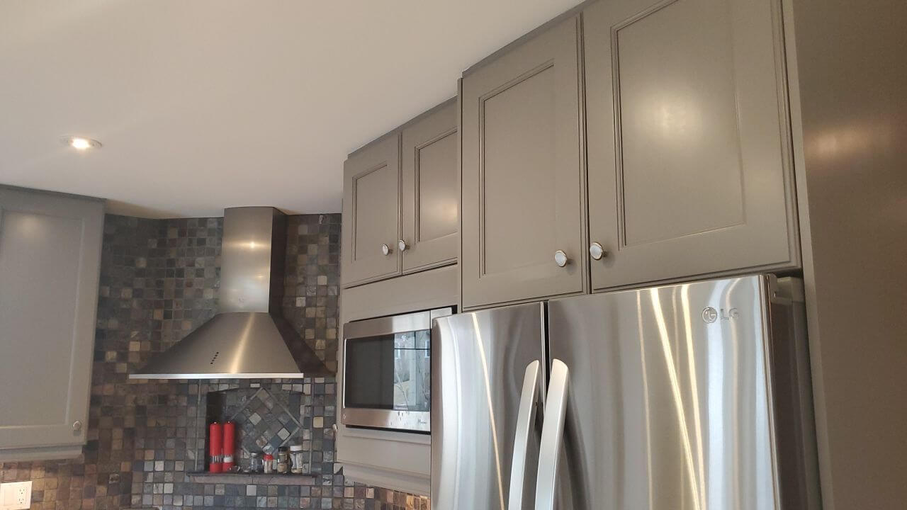 Flat white ceiling with modern grey tone painted cabinets