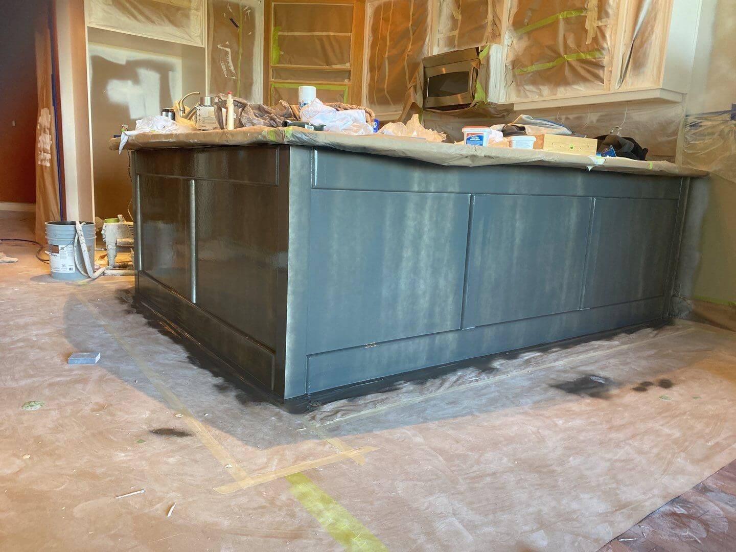 Downtown condo kitchen island in the middle of the spraying phase