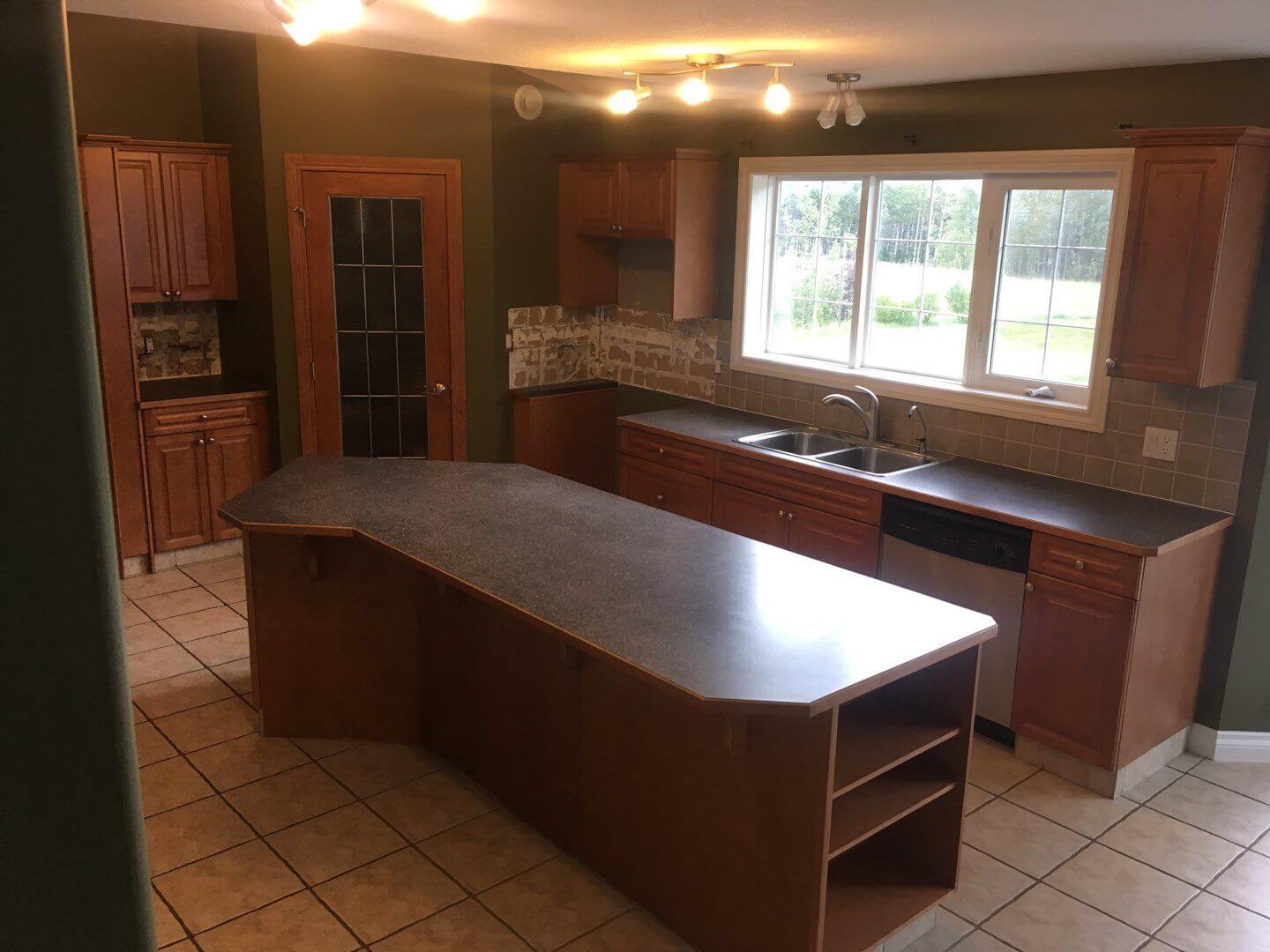 Stained wood kitchen before painting in Water Valley