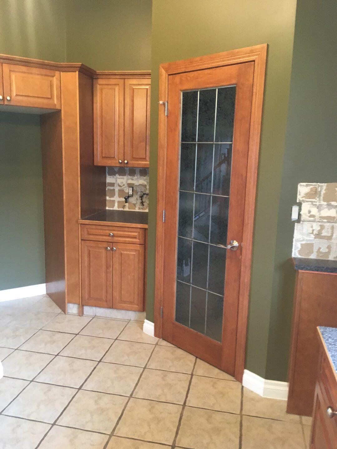 Stained wood cabinetry before painting in Water Valley