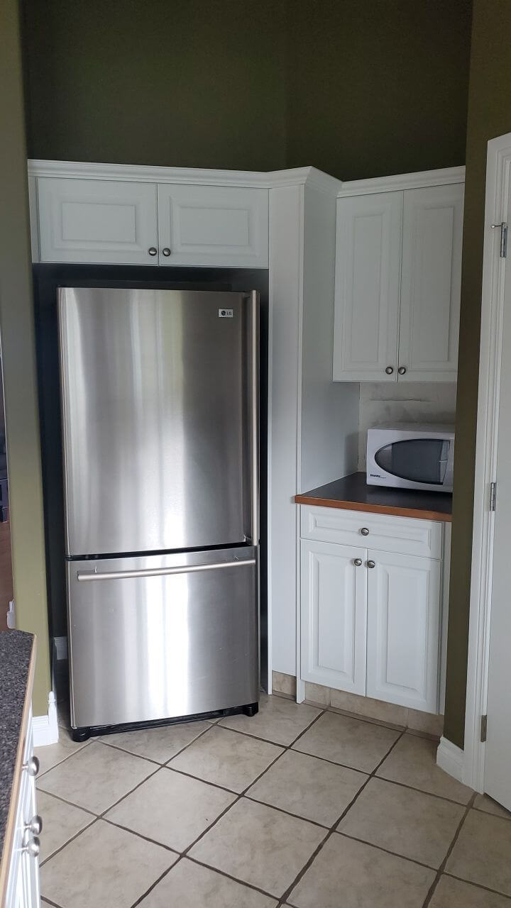 Modern white painted fridge cabinetry in Water Valley