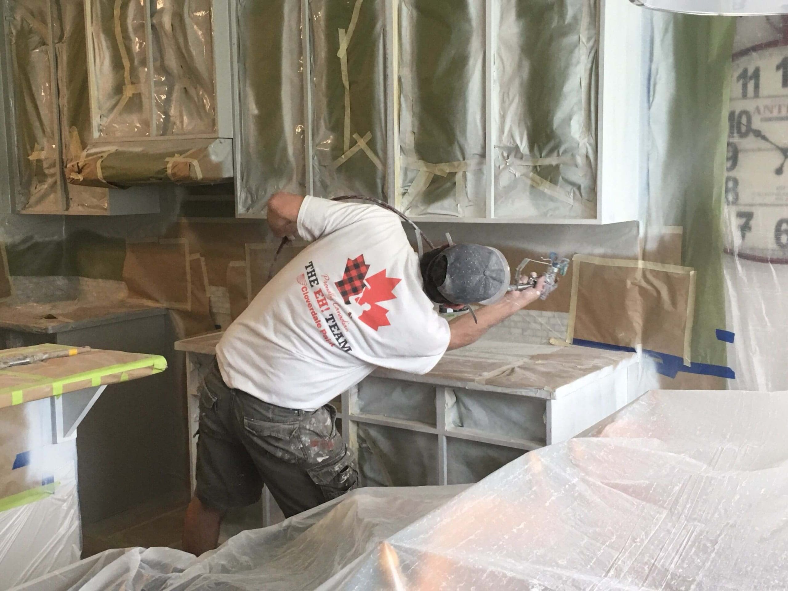 Spraying the underside of an upper cabinetry unit