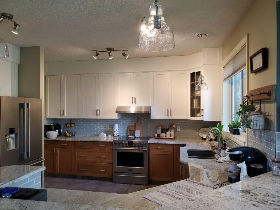 Two-tone stained lowers with painted white upper cabinets SW Calgary