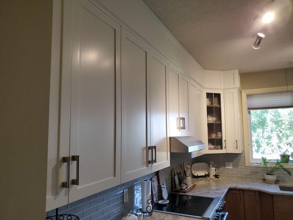 Modern white painted upper kitchen cabinets SW Calgary