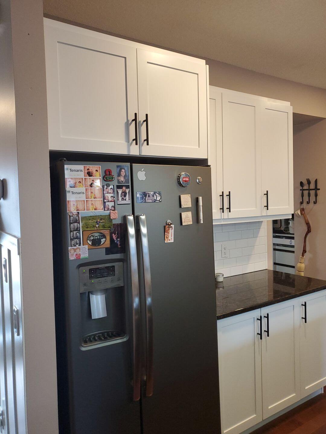 Fridge tower white painted cabinets with black hardware