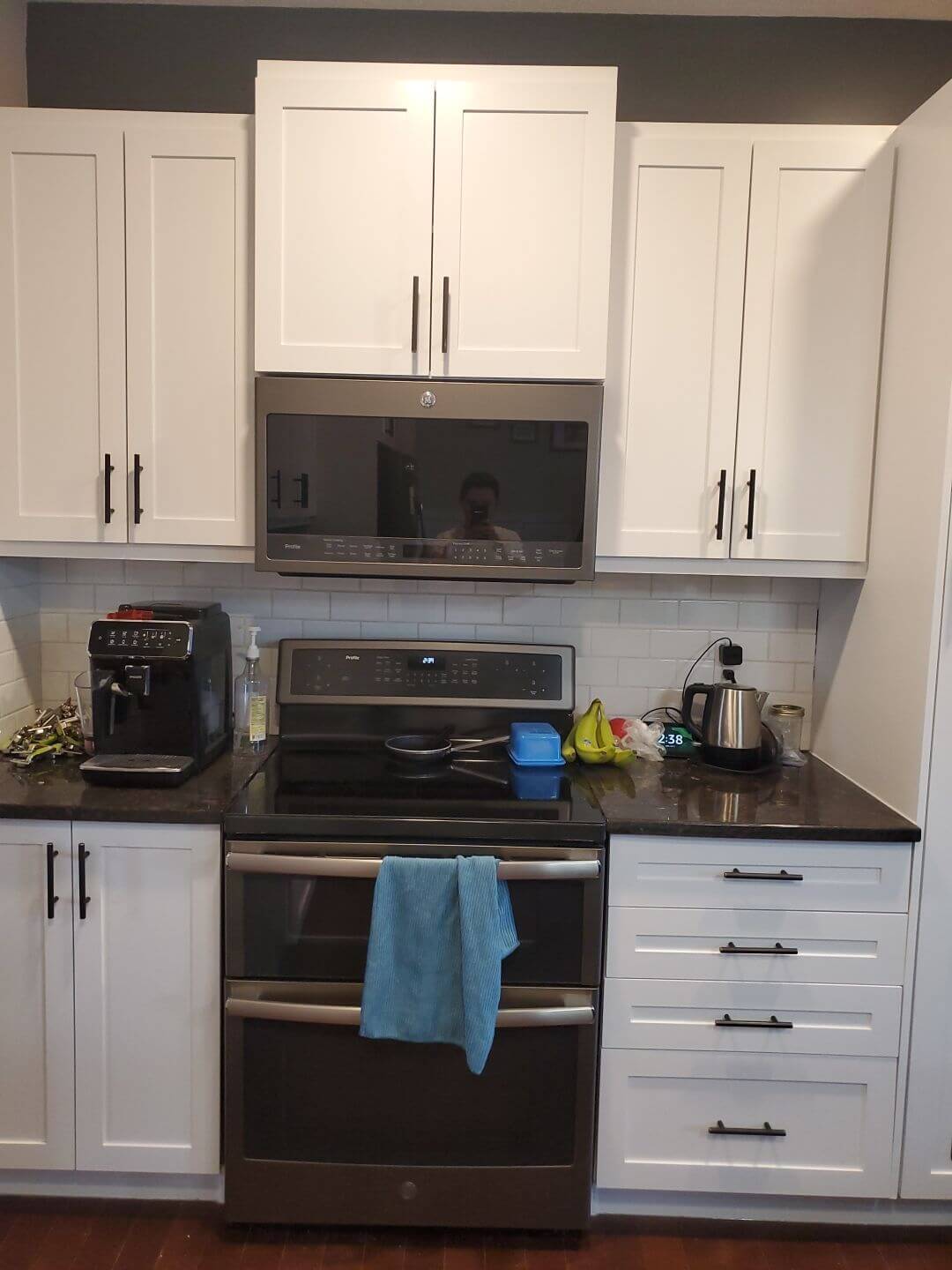 Bright white painted cabinetry featuring black accent hardware