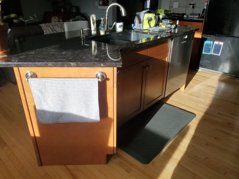 Orange maple island cabinets before being painted