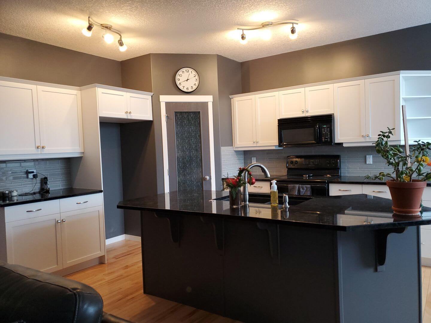 Bright white painted kitchen with black accent island