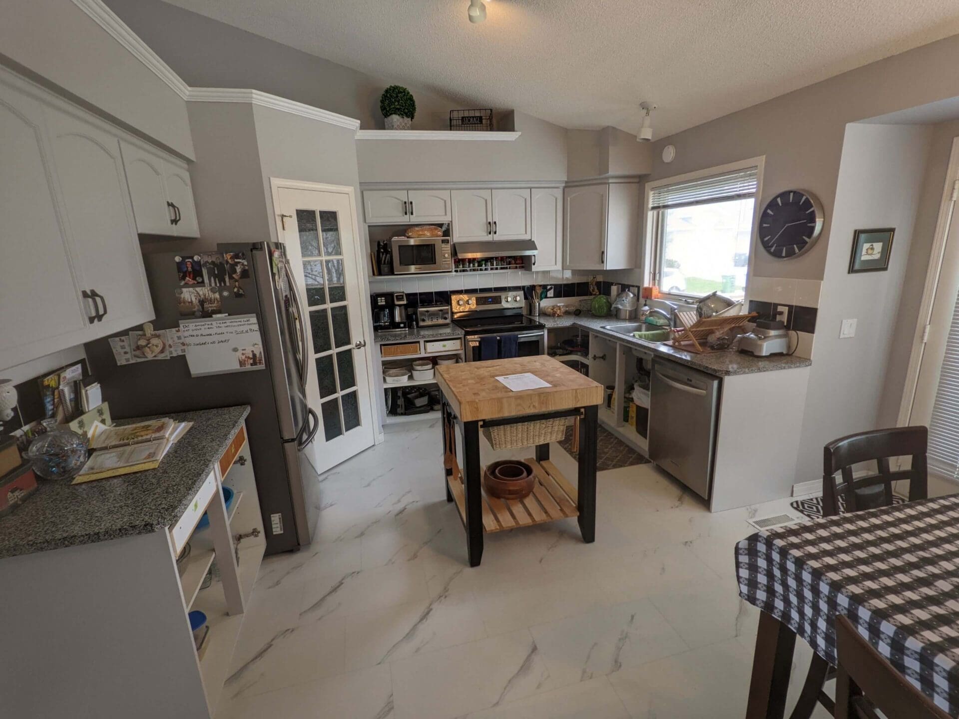 Cozy grey painted kitchen with chic black hardware