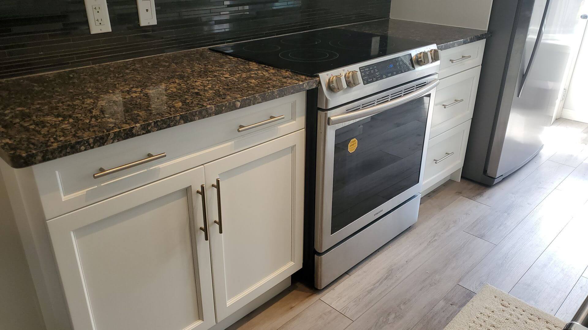 cream white after painting with dark counters and backsplash