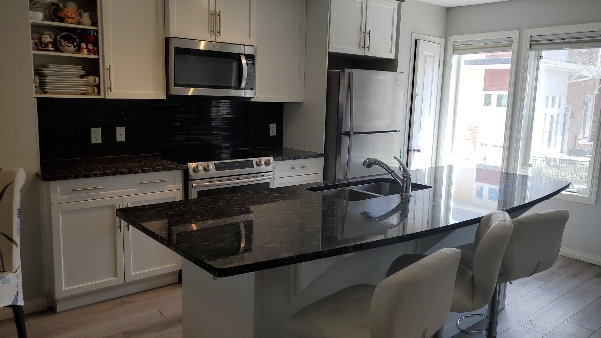 white painted cabinets with black counters