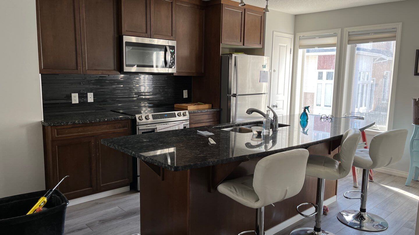 Dark brown maple kitchen before being painted