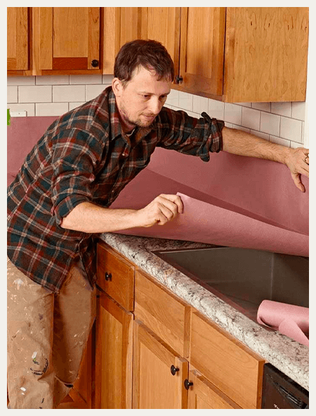 laying protection on a counter to protect from paint overspray